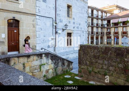 Irun, Gipuzkoa, pays Basque, Espagne - 10th juillet 2019 : Une femme passe devant l'église de Santa Maria del Juncal. Banque D'Images