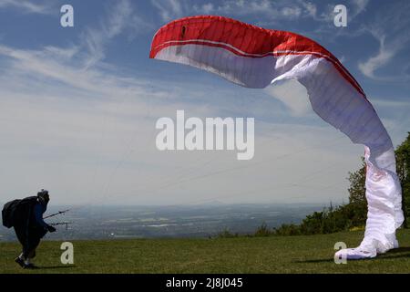 Kozakov, République tchèque. 16th mai 2022. Un parapente se prépare à partir d'un Kozakov (à 100 kilomètres au nord de Prague) pendant une journée ensoleillée dans le Paradis tchèque. Le parapente est un sport de vol de loisir et de compétition. Le pilote est assis dans un harnais suspendu sous une aile en tissu, dont la forme est formée par la pression de l'air entrant dans les évents à l'avant de l'aile. (Credit image: © Slavek Ruta/ZUMA Press Wire) Banque D'Images