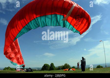 Kozakov, République tchèque. 16th mai 2022. Un parapente se prépare à partir d'un Kozakov (à 100 kilomètres au nord de Prague) pendant une journée ensoleillée dans le Paradis tchèque. Le parapente est un sport de vol de loisir et de compétition. Le pilote est assis dans un harnais suspendu sous une aile en tissu, dont la forme est formée par la pression de l'air entrant dans les évents à l'avant de l'aile. (Credit image: © Slavek Ruta/ZUMA Press Wire) Banque D'Images