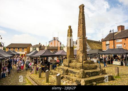 Les gens au marché des fermiers et des fabricants autour des croix saxonnes anciennes sur la place du marché pavée de la ville de marché Cheshire de Sandbach en Angleterre Banque D'Images