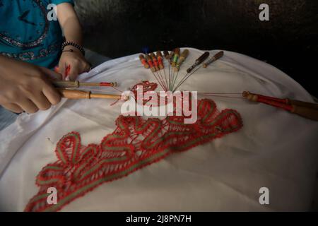 Une femme triant des motifs décoratifs sur le textile à l'aide d'un outil traditionnel à Sawahlunto, Sumatra Ouest, Indonésie. Banque D'Images