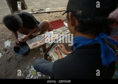 Les ouvriers qui polissaient des souvenirs d'ornement de type ambre dans une boutique située en bordure de route à Lembah Harau, Harau, Lima Puluh Kota, Sumatra Ouest, Indonésie. Banque D'Images