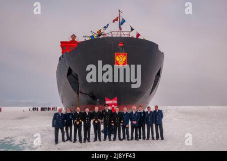 Le capitaine et les officiers des 50 ans de la victoire (50 Laissez Pobedy) brise-glace au pôle Nord géographique Banque D'Images