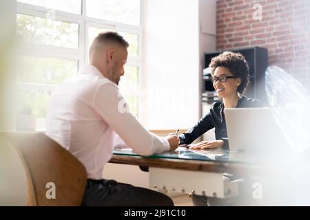 Jeune Conseiller financier facture discuter avec son client sur le lieu de travail Banque D'Images