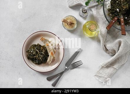 salade d'algues laminaria aux graines de sésame et à l'huile. Déjeuner ou dîner traditionnel. Utilisé pour manger avec des bâtonnets de pain. Aliments crus, végétaliens et végétariens sains Banque D'Images