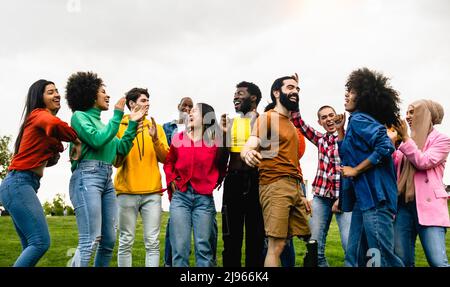 Jeunes amis multiraciaux s'amusant dansant ensemble dans le parc - concept d'amitié et de diversité Banque D'Images