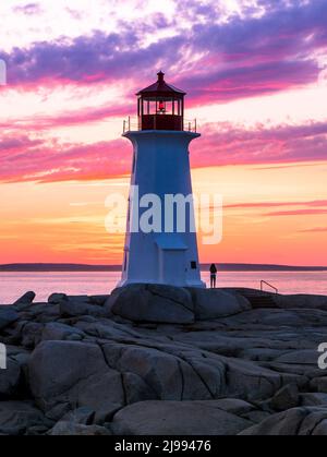 Peggy's Cove Lighthouse pendant un coucher de soleil vibrant. Côte Atlantique, Nouvelle-Écosse, Canada. L'endroit touristique le plus visité dans le Canada atlantique Banque D'Images