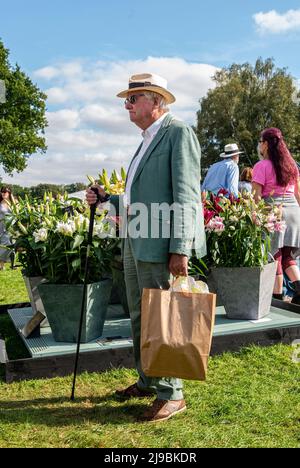 Un homme portant des tissus de style campagnard, dont un chapeau Panama et une canne, se tient parmi les visiteurs le premier jour du salon des fleurs de Harrogate d'automne au Newby Hall de Ripon en Angleterre. Banque D'Images