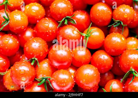 Tomates cerises fraîchement rincées à l'eau. Banque D'Images