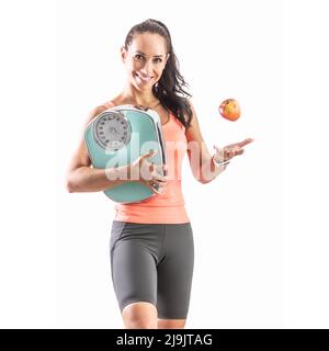 Les objectifs de forme physique atteints par le régime approprié comme la femme tenant l'échelle jette une pomme. Banque D'Images