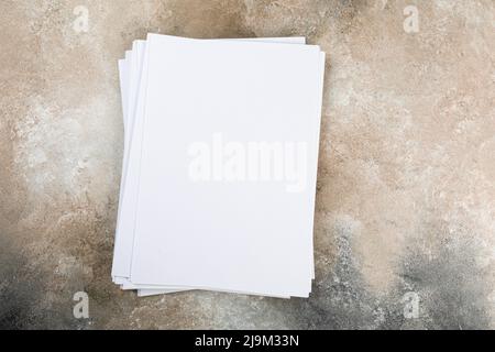 pile de feuilles de cartes de visite blanches a4 piles sur la table de coulis. Banque D'Images