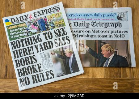 24 mai 2022. Les pages de couverture de Daily Express et Daily Telegraph remettent en question le jugement de la police métropolitaine alors que de nouvelles photos émergent des parties de confinement de Boris Johnson et Downing Street. Banque D'Images