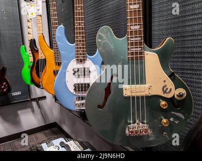 Lynnwood, WA USA - vers mai 2022: Vue de divers guitares basses en vente dans un magasin d'instruments de musique Guitar Center. Banque D'Images