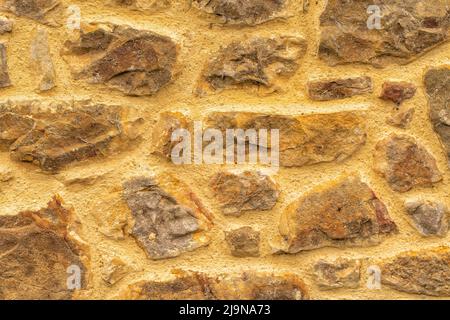 Un arrière-plan ou une texture de mur de pierre brun ciré Banque D'Images