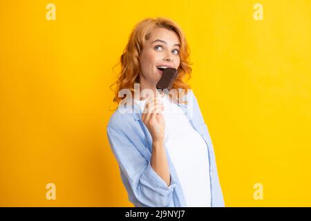 Portrait de mode jeune femme fraîche avec de la crème glacée sur fond jaune. Jeune fille hipster cheeky mangeant une glace à coller. Banque D'Images