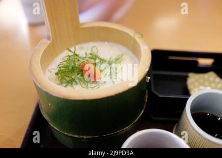 Un traditionnel lait de soja de style Kyoto et tofu chaud servi dans un bol de bambou (cuisine de Kansai) - Arashiyama, Kyoto, Japon. Banque D'Images