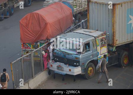 25 mai 2022, Lahore, Punjab, Pakistan : Les navetteurs et les chauffeurs pakistanais qui dorment dans leur véhicule sur un pont au-dessus de la rivière Ravi le long d'une route partiellement bloquée par des conteneurs par les autorités locales afin d'entraver la mobilité avant le sit-in prévu à Islamabad par le parti Pakistan Tehreek-e-Insaf (PTI), l'ancien Premier ministre pakistanais Imran Khan à Lahore. Le principal parti d'opposition du Pakistan, dirigé par le Premier ministre récemment évincé Imran Khan, a accusé la police de détenir des centaines de ses partisans lors de raids qui ont commencé mardi. Un sit-in important a été planifié par l'ancien dirigeant, les membres de haut rang du parti et p Banque D'Images