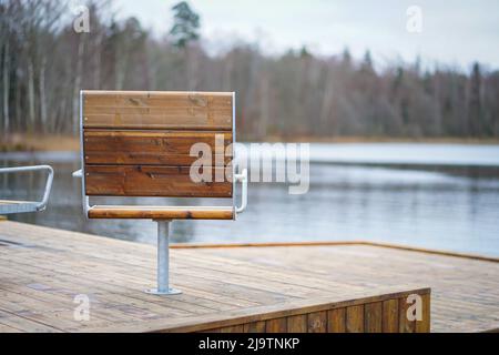 Métal avec une couverture en bois chaises modernes dans l'espace détente en face du lac Banque D'Images