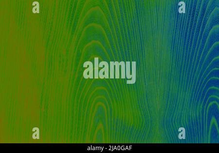 Motif abstrait en bois dans les tons vert, bleu et orange. Traitement artistique de l'image créé à partir de la photo de surface en placage de bois. Belle texture en bois dos Banque D'Images