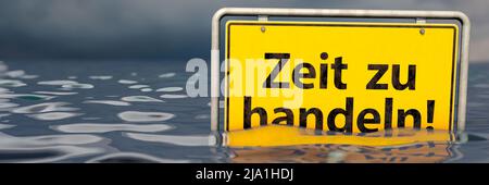 Signe allemand du nom du lieu: Zeit zu handeln (temps d'agir) Banque D'Images