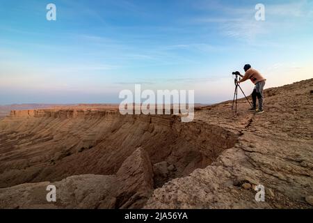 Photographe d'aventure à Edge of the World, un site naturel et une destination touristique populaire près de Riyad -Arabie Saoudite. Banque D'Images