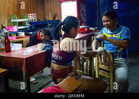 Kriswarakarn Srivichai (R) donne une indication à Naem Peaw (L) avant son combat au stade de boxe international de Thapae. Il y a des années, voir des femmes dans un ring Fighting (Muay Thai) en Thaïlande était presque inentendu de, à moins qu'il ne soit dans un combat cérémonial dans le temple local pendant la saison de fête. De nos jours, les choses changent et de plus en plus de femmes rejoignent le sport. La ville de Chiang Mai est l'épicentre de ce changement avec le soutien d'un promoteur local qui voit le sport comme un moyen de promouvoir l'égalité, et l'intérêt croissant dans le sport par les étrangers qui affluent dans la ville. Dans un peu Muay Banque D'Images