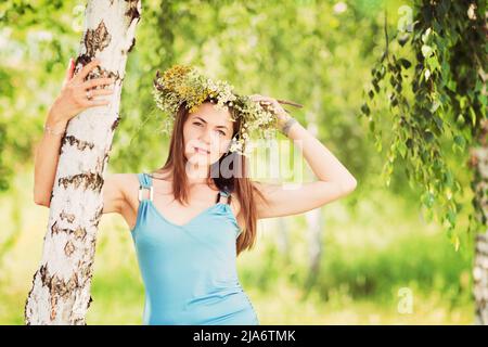 Jolie jeune femme avec une couronne de fleur sur sa tête Banque D'Images