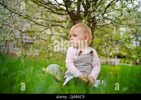 fille dans un jardin de cerisiers en fleurs Banque D'Images