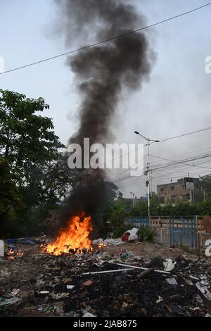 Howrah, Inde. 28th mai 2022. Brûler des déchets avec du plastique et d'autres déchets solides est nocif pour l'environnement car ces matériaux libèrent des produits chimiques toxiques qui polluent l'air et qui peuvent être inhalés par les humains et les animaux, et déposés dans le sol et les eaux de surface et sur les plantes dans la ville dense de Howrah. (Photo de Biswarup Ganguly/Pacific Press) crédit: Pacific Press Media production Corp./Alay Live News Banque D'Images