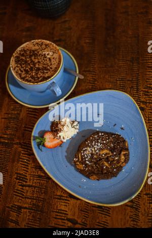Vue en hauteur d'un chocolat et d'un petit gâteau aux noix avec un chocolat chaud sur une table Banque D'Images