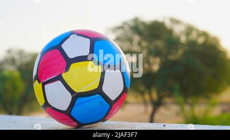 Volleyball sous la lumière du soleil et ciel bleu. Balle avant match, isolée sur le toit. Équipements de sport et de santé. Banque D'Images