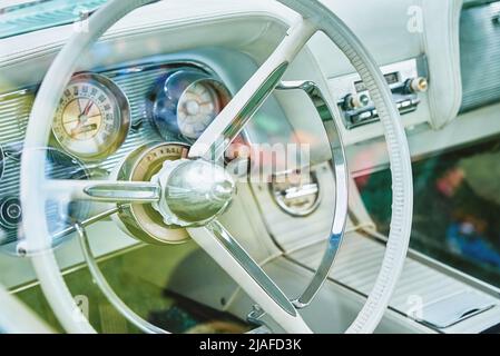 Voiture rétro intérieur lumineux, tableau de bord et volant avec commandes dans une voiture américaine classique Banque D'Images