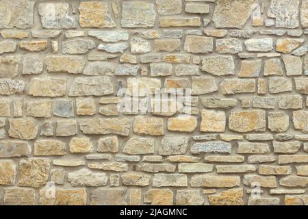 Mur en pierre jaune et beige Uni. Arrière-plan en pierre. Banque D'Images