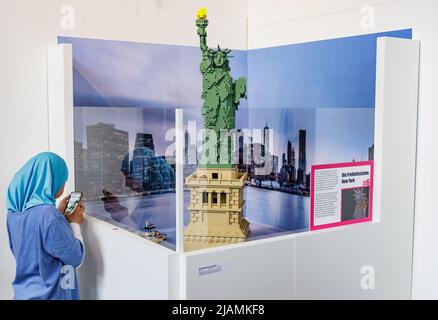 Hambourg, Allemagne. 31st mai 2022. Une écolière prend une photo d'un modèle de la Statue de la liberté dans l'exposition « LEGO® - voyage fantastique de Lisa et Mad dans l'espace et le temps ». Le monde de la fantaisie au Musée Emigrant de Ballinstadt, assemblé à partir de plus de 500 000 blocs de construction, sera exposé de 01 juin à 26 août 2022. Credit: Axel Heimken/dpa/Alay Live News Banque D'Images