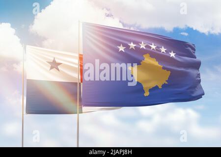 Ciel bleu ensoleillé et drapeaux du kosovo et du panama Banque D'Images