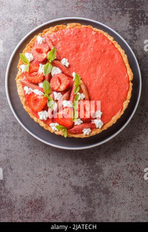 Mousser les fraises, le rhubarbe, la menthe et la crème fouettée sur la table. Vue verticale du dessus Banque D'Images