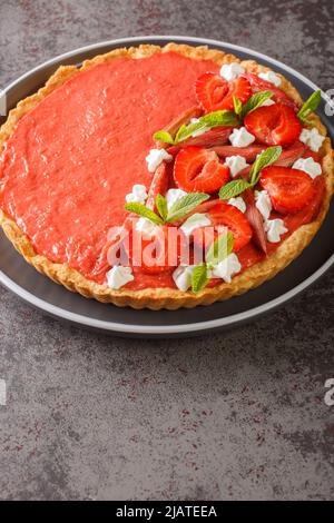 Mousser les fraises, le rhubarbe, la menthe et la crème fouettée sur la table. Verticale Banque D'Images