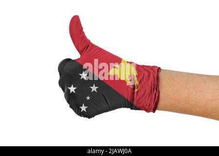 Drapeau de la Papouasie-Nouvelle-Guinée sur un gant montrant le pouce vers le haut Banque D'Images