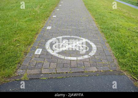 Sentier en pierre avec un panneau peint sur celui-ci interdisant le vélo. Concept de sécurité. Banque D'Images