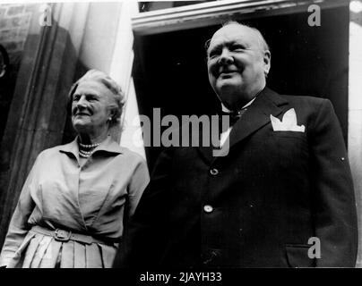 Churchill à Downing Street pour une réception après Eden Wedding: Le premier ministre Winston Churchill sourit sur la foule devant le numéro 10, Downing Street, comme avec Mme Churchill il arrive à sa résidence après le mariage à Caxton Hall du ministre des Affaires étrangères Anthony Eden et Mlle Clarissa Spencer-Churchill. Mme Churchill est une nièce du premier ministre. La réception a eu lieu au numéro 10. 14 août 1952. Banque D'Images