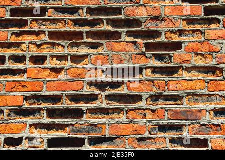 arrière-plan, texture d'un vieux mur de briques rouges très abîmé Banque D'Images