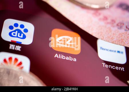 Logo Alibaba, fondé le 4 avril 1999 à Hangzhou, dans le Zhejiang, avec logos de grandes entreprises chinoises de technologie (Baidu, Tencent et Huawei) et argent sur iPhone. Banque D'Images