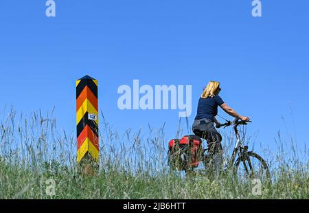 03 juin 2022, Brandebourg, Reitwein: Un cycliste est en promenade sur la piste cyclable Oder-Neisse, qui est située dans l'Oderbruch sur la digue de la frontière germano-polonaise Oder. La piste cyclable Oder-Neisse est une piste cyclable longue distance en République tchèque et en Allemagne d'environ 630 kilomètres de long. Elle suit largement la frontière orientale de l'Allemagne avec la Pologne. La route à vélo Oder-Neisse s'étend vers le sud-nord sur environ 55 kilomètres à travers la République tchèque, en partant de la source de la rivière Neisse et en la suivant jusqu'à l'endroit où la Neisse se jette dans l'Oder. Vers l'ouest de l'Oder, le trai Banque D'Images