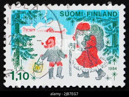 FINLANDE - VERS 1984 : un timbre imprimé en Finlande montre le Père Noël et un enfant, vers 1984 Banque D'Images