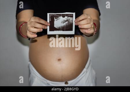 jeunes femmes enceintes montrant son sonogramme avec ventre rond ventre womb de différents angles Banque D'Images