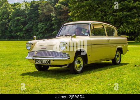 1965 60s années soixante jaune Ford Anglia 997 cc saloon essence arrivant à Worden Park Motor Village pour le Festival Leyland, Royaume-Uni Banque D'Images