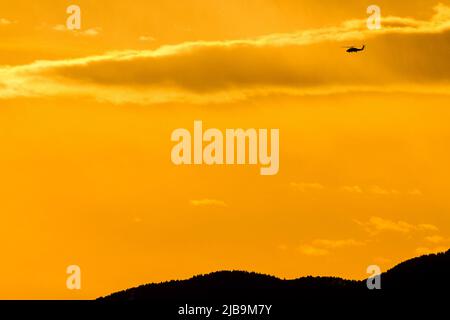 Les hélicoptères Sikorsky SH-60 Seahawk survolant Chou Rinkan, Kanagawa au coucher du soleil. Banque D'Images