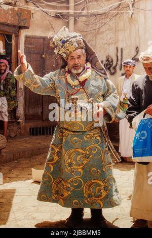 Un vieil homme en robe traditionnelle parcourant les rues du vieux Sanaa Banque D'Images