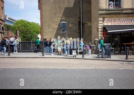 Personnes regardant le puits Hung Lover par Banksy sur Park Street, Bristol, Royaume-Uni (Jun22) Banque D'Images