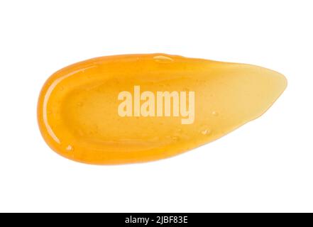 Frottis de gel transparent orange avec bulles isolées sur fond blanc vue de dessus Banque D'Images